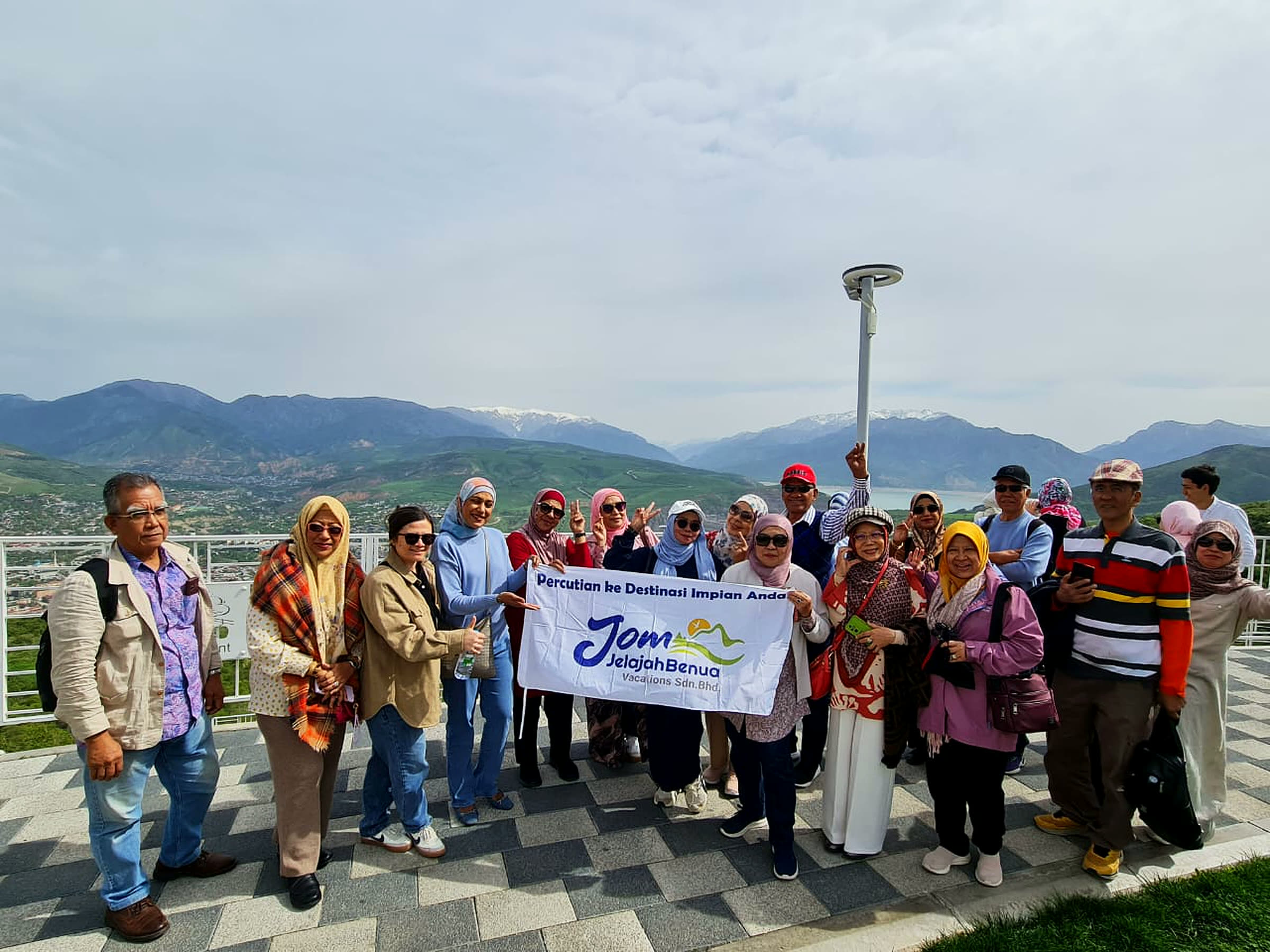 Jom Jelajah Benua travellers with the company banner in Uzbekistan